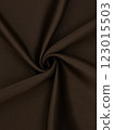 Close-up of twisted brown curtain fabric texture in smooth folds 123015503
