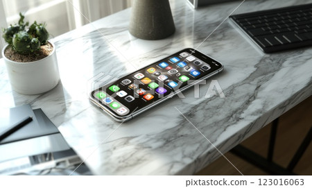 Smartphone on marble desk with keyboard, plant, and sunlight. Smartphone on marble desk with keyboard, plant, and sunlight. 123016063
