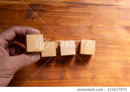 Person holding a blank wooden block Person holding a blank wooden block 123017073