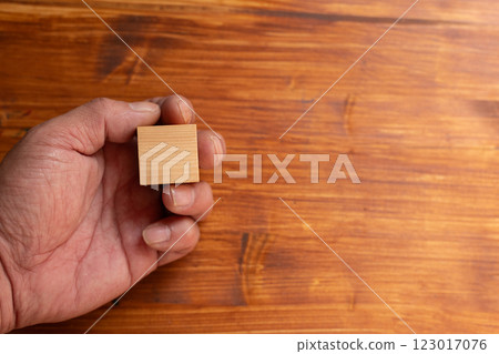 Person holding a blank wooden block Person holding a blank wooden block 123017076