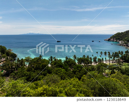 Tropical coastline surrounded by lush greenery, turquoise water, and scattered boats in the distance. Koh Tao, Thailand. Tropical coastline surrounded by lush greenery, turquoise water, and scattered boats in the distance. Koh Tao, Thailand. 123018649