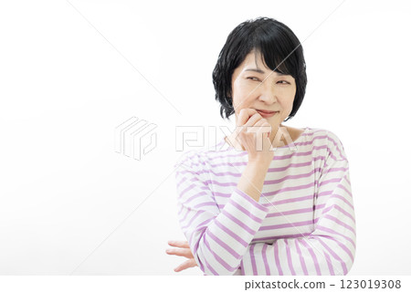 A middle-aged woman in a striped shirt grinning 123019308