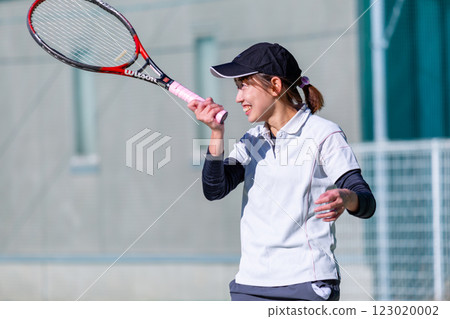 A woman playing tennis A woman playing tennis 123020002