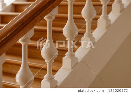 Luxurious wooden staircase with white balusters. Luxurious wooden staircase with white balusters. 123020372