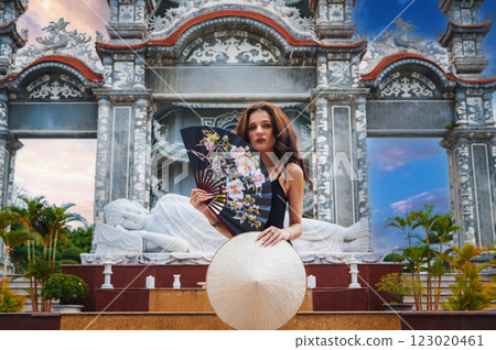 beautiful female tourist traveler at temple on Buddhist pagoda in Da Nang, Vietnam. Travel and tourism in Asia beautiful female tourist traveler at temple on Buddhist pagoda in Da Nang, Vietnam. Travel and tourism in Asia 123020461