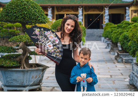 family of tourists mom and son at Buddhist temple at Linh Ung Pagoda in Da Nang in Vietnam. Travel and tourism in Asia 123020462