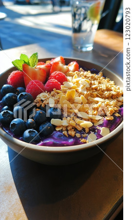 Healthy smoothie acai bowl topped with granola, strawberries, blueberries, and mint Healthy smoothie acai bowl topped with granola, strawberries, blueberries, and mint 123020793