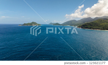 Granite boulders and ocean surf, set against a backdrop of verdant tropical forest. Seychelles, Mahe. Granite boulders and ocean surf, set against a backdrop of verdant tropical forest. Seychelles, Mahe. 123021177