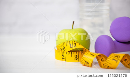 Healthy snack for diet planning.  Fresh  fruit with green fruit and tape measure white background.  123021276