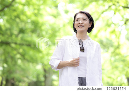 Middle-aged woman walking in the park Middle-aged woman walking in the park 123021554