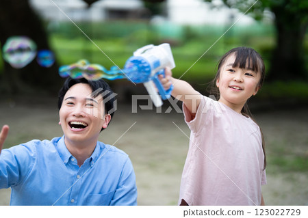 Parents and children playing with soap bubbles Parents and children playing with soap bubbles 123022729