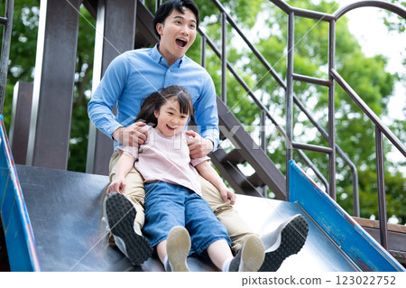 Parents and children playing on the slide 123022752
