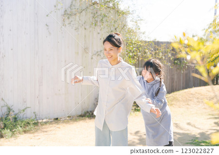Two women playing in the garden 123022827