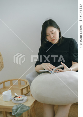 pet care concept with owner during read book and take coffee break in livingroom pet care concept with owner during read book and take coffee break in livingroom 123025132