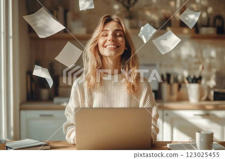 Joyful woman working on laptop cozy home office lifestyle warm environment bright viewpoint 123025455