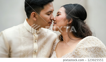 Romantic moment between young asian couple in traditional wedding attire 123025551