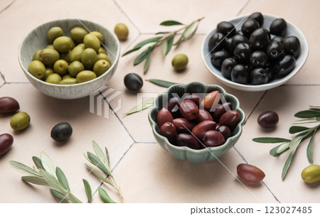 Assorted olives in ceramic bowls with leaves Assorted olives in ceramic bowls with leaves 123027485