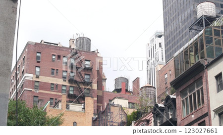 New York City Manhattan architecture, USA. Residential house exterior. Red brick facade, water tower 123027661