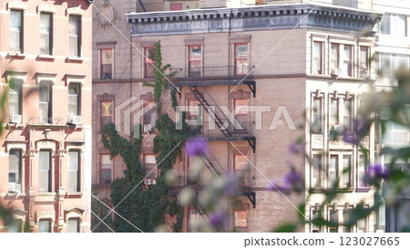New York City building architecture, Manhattan. Residential house exterior. Red brick, fire escape. 123027665
