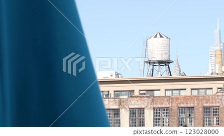 New York City industrial building exterior architecture, USA. Red brick facade. Rooftop water tower. 123028000