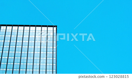 A striking minimalist composition, emphasizing contrast between the rigid lines of the building and the vast, open sky. The clean, modern aesthetic highlights architectural simplicity. A striking minimalist composition, emphasizing contrast between the rigid lines of the building and the vast, open sky. The clean, modern aesthetic highlights architectural simplicity. 123028815