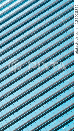 A mesmerizing architectural shot where diagonal lines and reflective glass panes create a dynamic, almost hypnotic pattern of symmetry and depth A mesmerizing architectural shot where diagonal lines and reflective glass panes create a dynamic, almost hypnotic pattern of symmetry and depth 123028832