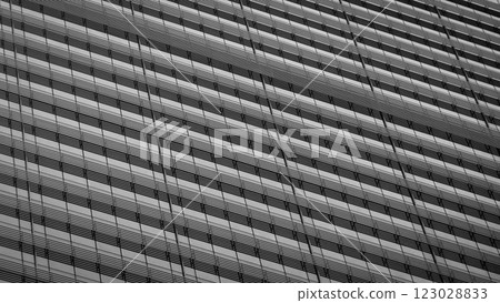 A striking black-and-white capture of a modern facade, where repeating lines and geometric forms create a hypnotic rhythm of light and shadow. 123028833