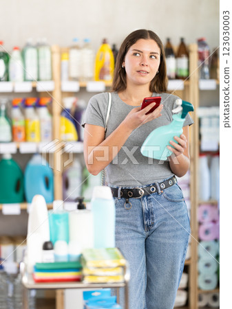 Woman scanning package with spray Woman scanning package with spray 123030003