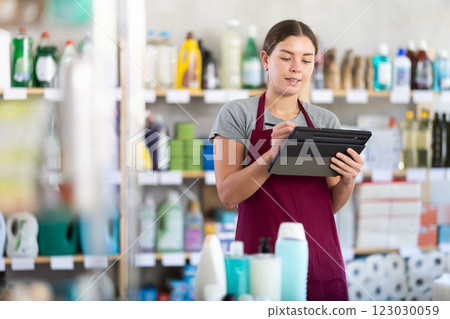 Woman seller doing inventory using tablet 123030059
