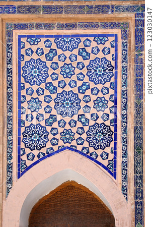 Vertical background with detail of ancient mosaic wall of Sher-dor Madrassah, Registan complex, Samarkand, Uzbekistan. Traditional iranian tile decorations Vertical background with detail of ancient mosaic wall of Sher-dor Madrassah, Registan complex, Samarkand, Uzbekistan. Traditional iranian tile decorations 123030147