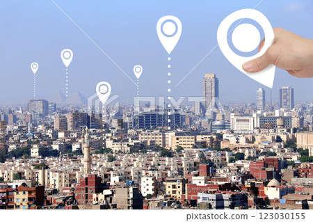 Planning a tourist trip. Top view of Cairo with Great Pyramids and hand with location pin. Travel way, point navigation concept. Global positioning system pin map. Modern travel, sightsee, tourism Planning a tourist trip. Top view of Cairo with Great Pyramids and hand with location pin. Travel way, point navigation concept. Global positioning system pin map. Modern travel, sightsee, tourism 123030155