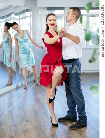 Elegant couple rehearsing sensual wedding dance in studio Elegant couple rehearsing sensual wedding dance in studio 123030299