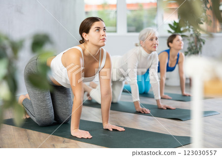 Young woman doing yoga in fitness studio 123030557