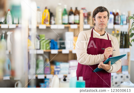 Adult man seller conducting inventory in store Adult man seller conducting inventory in store 123030613