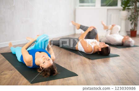 Adult woman doing yoga in fitness studio 123030986