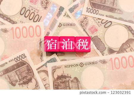 10,000 yen bill and accommodation tax written on a block Economy 10,000 yen bill and accommodation tax written on a block Economy 123032391