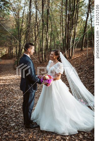 Portrait of beautiful bride and an elegant groom in nature, surrounded by a forest. Portrait of beautiful bride and an elegant groom in nature, surrounded by a forest. 123032586