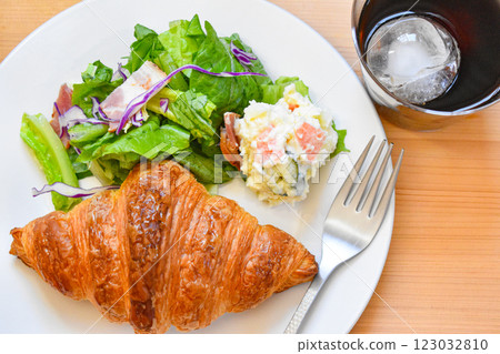 新鮮出爐的羊角麵包和新鮮的沙拉早餐盤 新鮮出爐的羊角麵包和新鮮的沙拉早餐盤 123032810