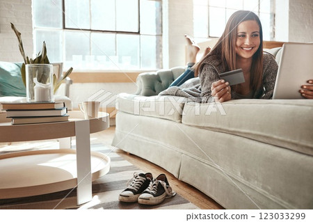 Relax, mobile app and credit card, happy woman on couch with tablet and internet banking in home. Ecommerce technology, online shopping payment and girl on sofa surfing retail website or digital shop Relax, mobile app and credit card, happy woman on couch with tablet and internet banking in home. Ecommerce technology, online shopping payment and girl on sofa surfing retail website or digital shop 123033299