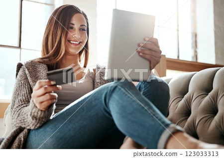 Happiness, tablet and credit card, woman on sofa in living room and internet banking or fintech in home. Technology, online shopping payment and girl on couch surfing retail website or digital shop. 123033313