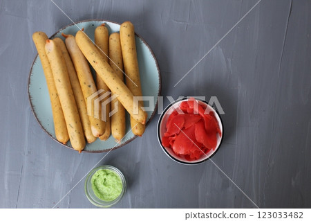 Sausages with red white sauce on a gray background, top view, shooting of breakfast products in the studio. The concept of a homemade breakfast snack Sausages with red white sauce on a gray background, top view, shooting of breakfast products in the studio. The concept of a homemade breakfast snack 123033482