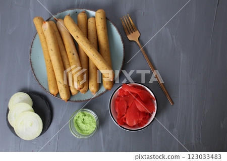 Served breakfast: Sausages on a plate with white sauce, red pickled ginger and white cheese, top view. Fast Car Concept Served breakfast: Sausages on a plate with white sauce, red pickled ginger and white cheese, top view. Fast Car Concept 123033483