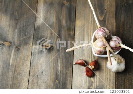 Garlic cloves purple color on gray background close-up with space for copy space text Garlic cloves purple color on gray background close-up with space for copy space text 123033501