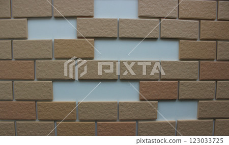 Missing tiles in decorative brickwork on a white wall stock photo for backgrounds 123033725