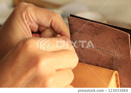 Sewing with thread in leather craft 123033869
