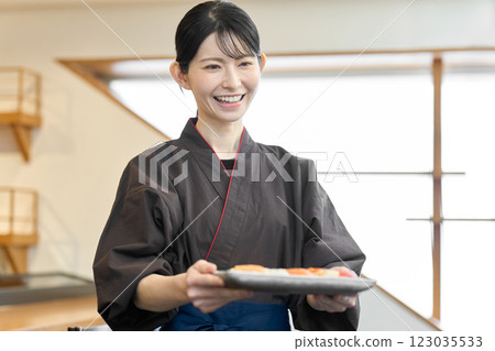 A Japanese restaurant employee carrying food 123035533