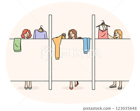 Women change clothes in stores changing room standing behind screen choose clothes before purchasing 123035648