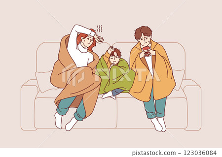 Caught cold family sits on sofa wrapped in blanket and drinks hot tea trying to get rid of virus 123036084