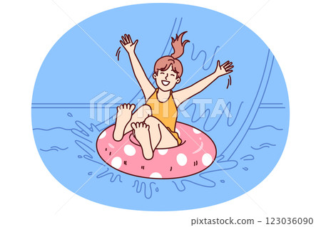 Little girl in pool floats on inflatable ring and enjoys visiting aqua park in sunny summer weather 123036090