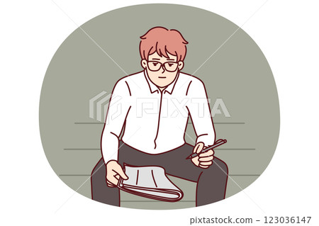 Unemployed man with newspaper is looking for vacancies while sitting on park bench 123036147